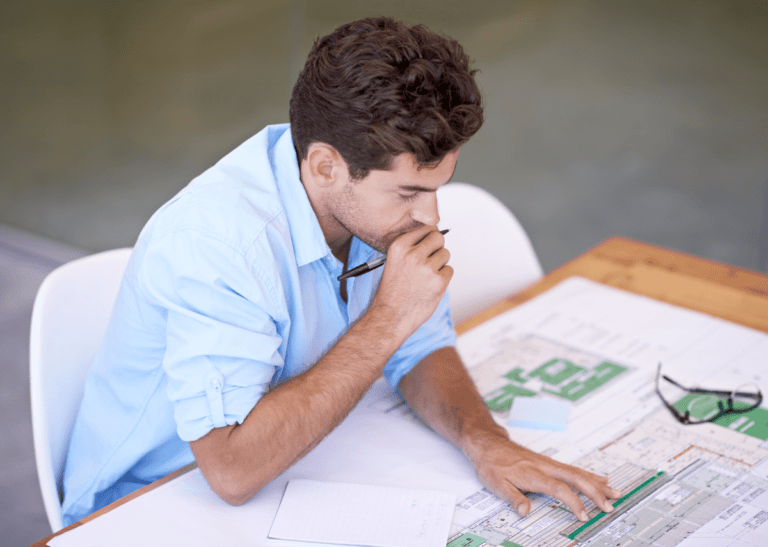 architect looking at blueprint